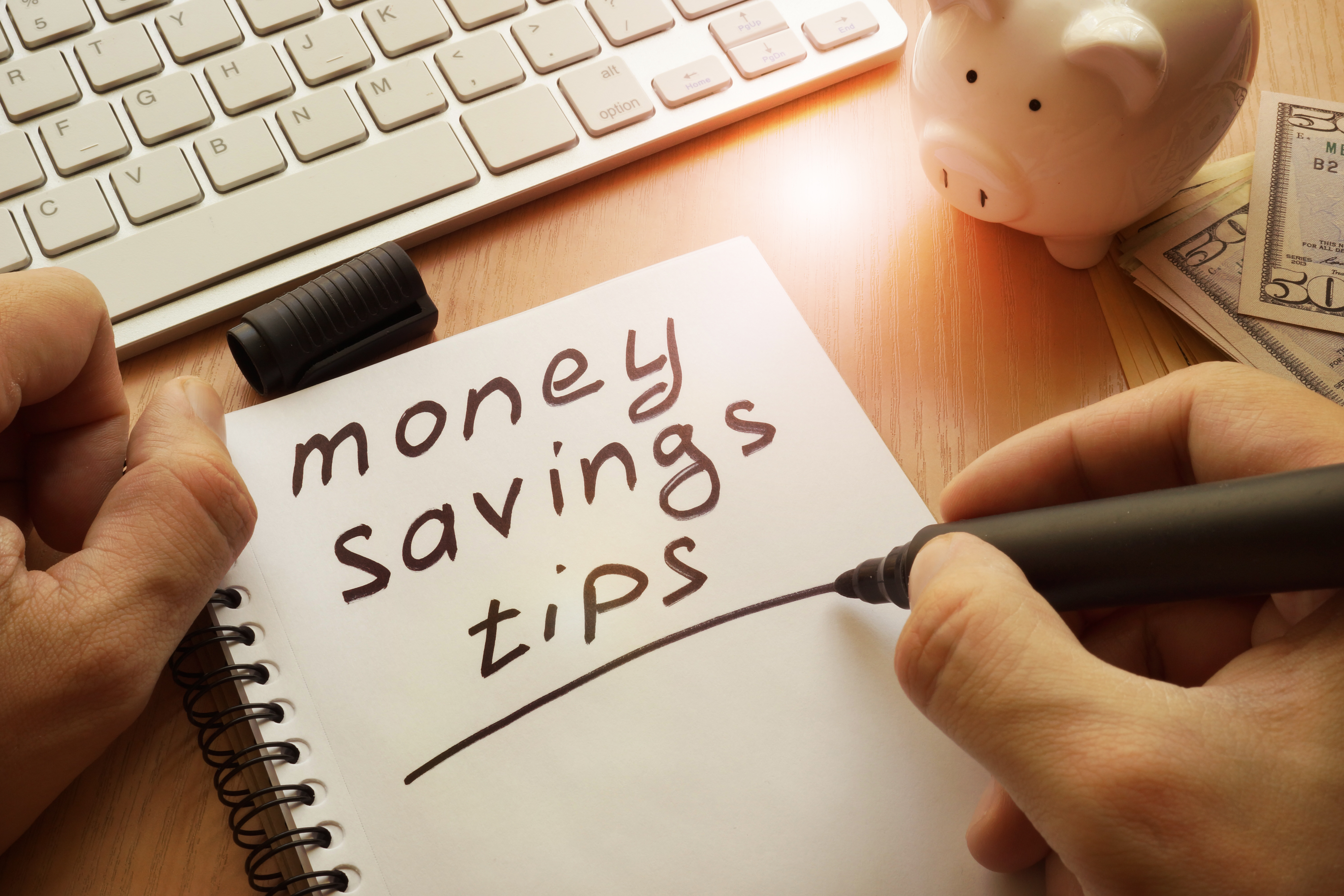 note pad that says "money saving tips"